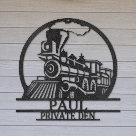 Personalised steam locomotive steel sign in black mounted on a shed wall with 'Paul - private den' shown as personalisation example