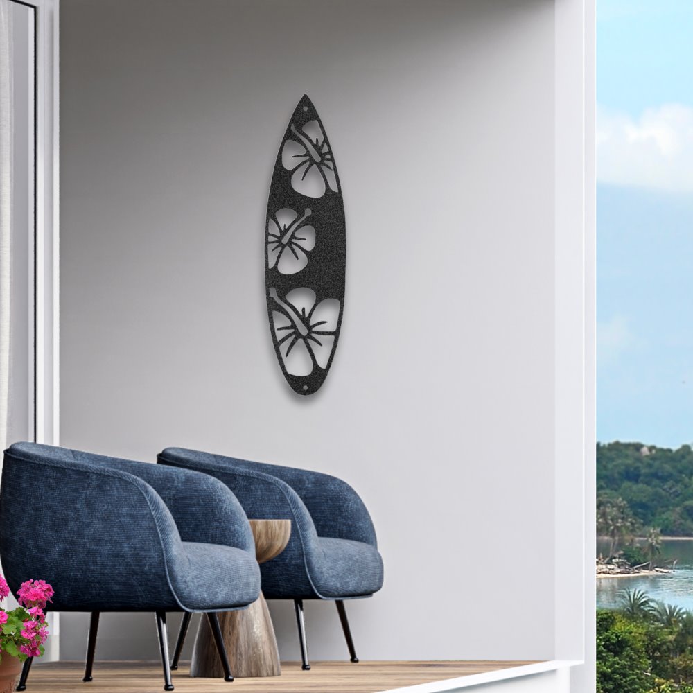 Decorative black steel sign in the shape of a surf board with hibiscus flower design shown on white balcony wall