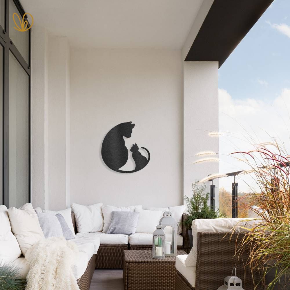 Kitten Love cats abroad metal sign shown on the white painted wall of a terrace