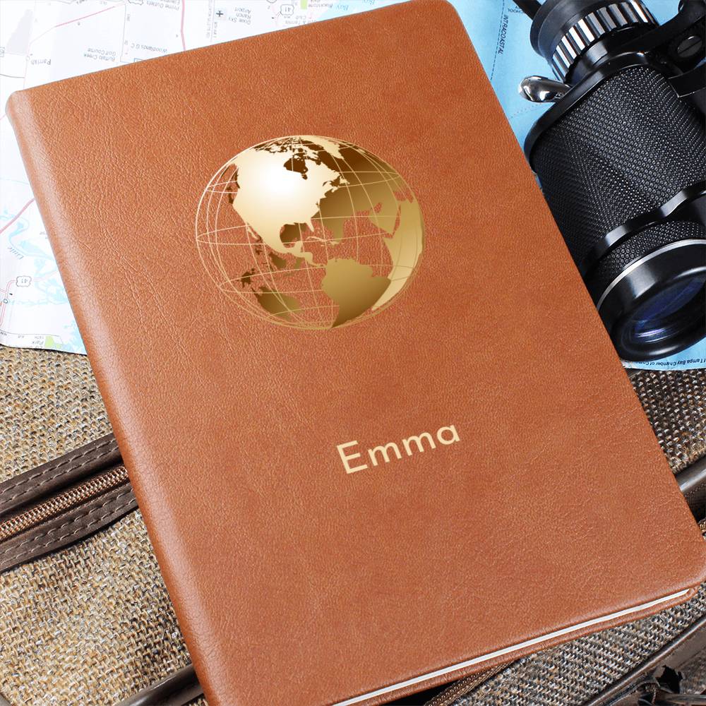 Photo of front of tan vegan leather travel journal. It has a golden globe graphic and a personalised name 'Emma'