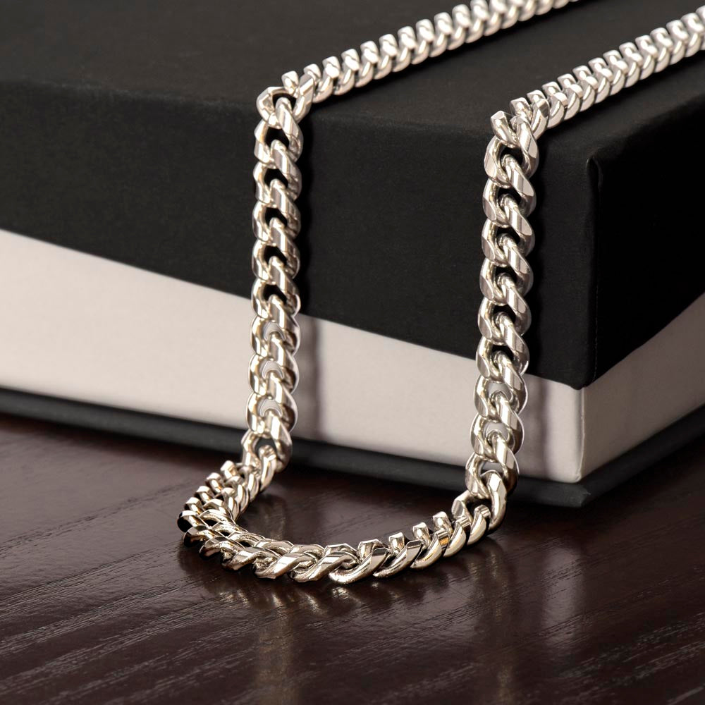 Stainless steel Cuban style link chain necklace shown draped over the corner of a standard gift box