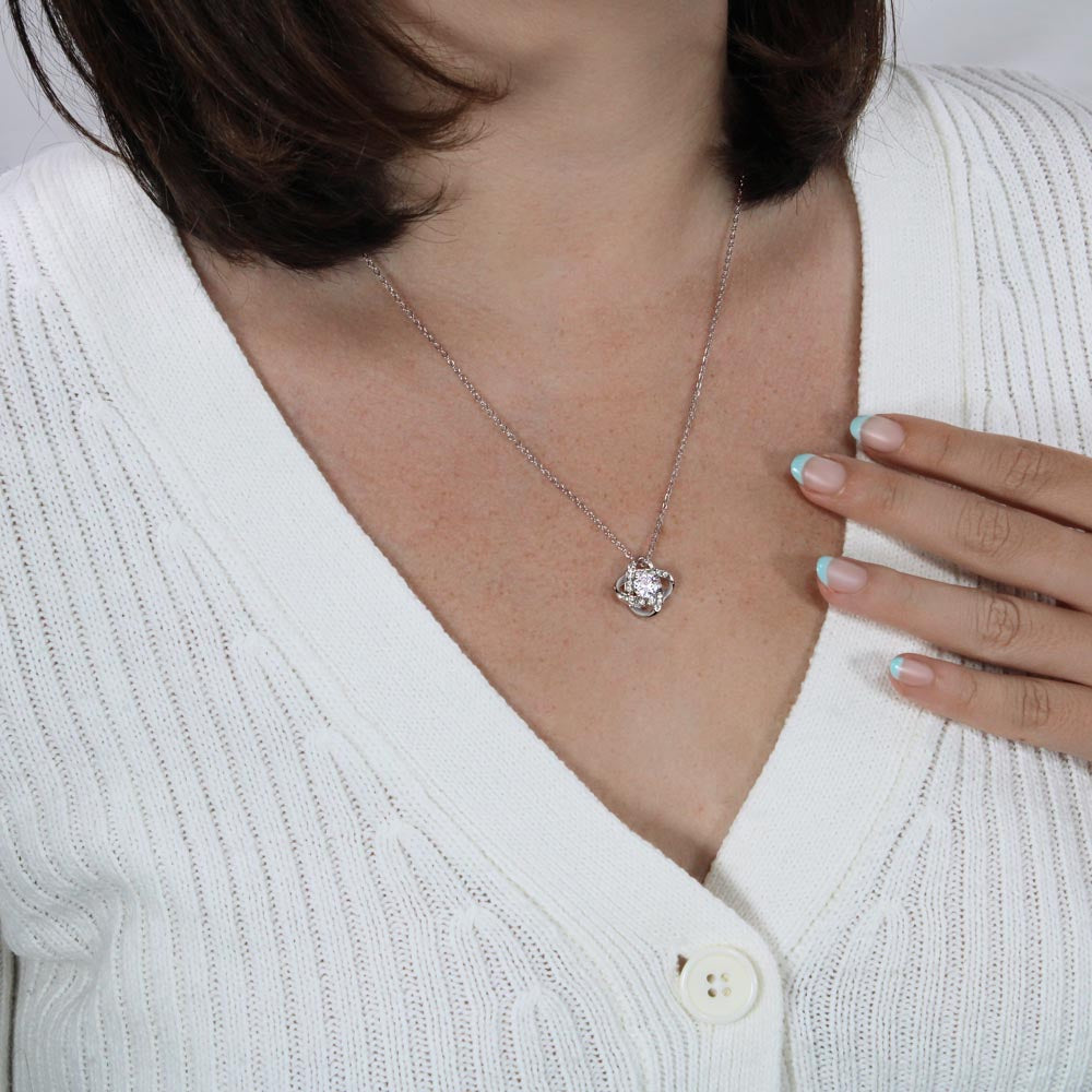 White gold friendship knot necklace shown around a woman's neck