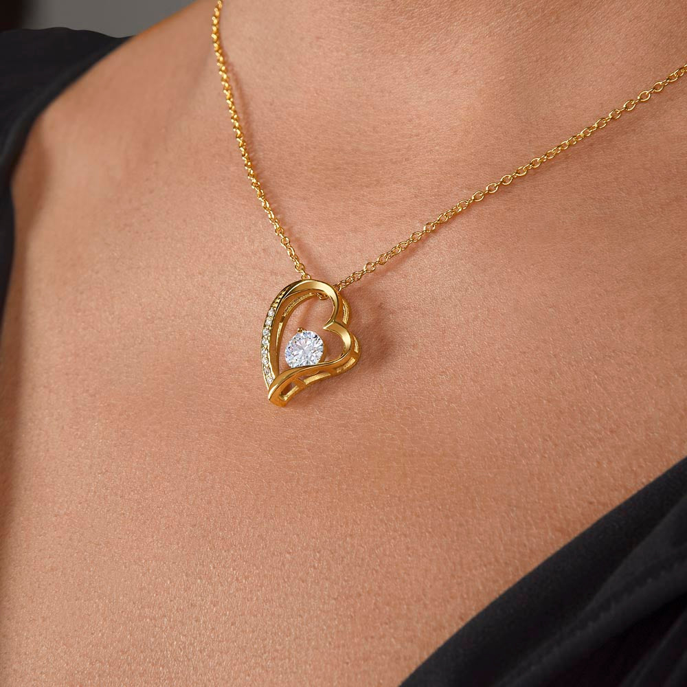 Gold dipped sparkling heart necklace shown worn on a woman's neck