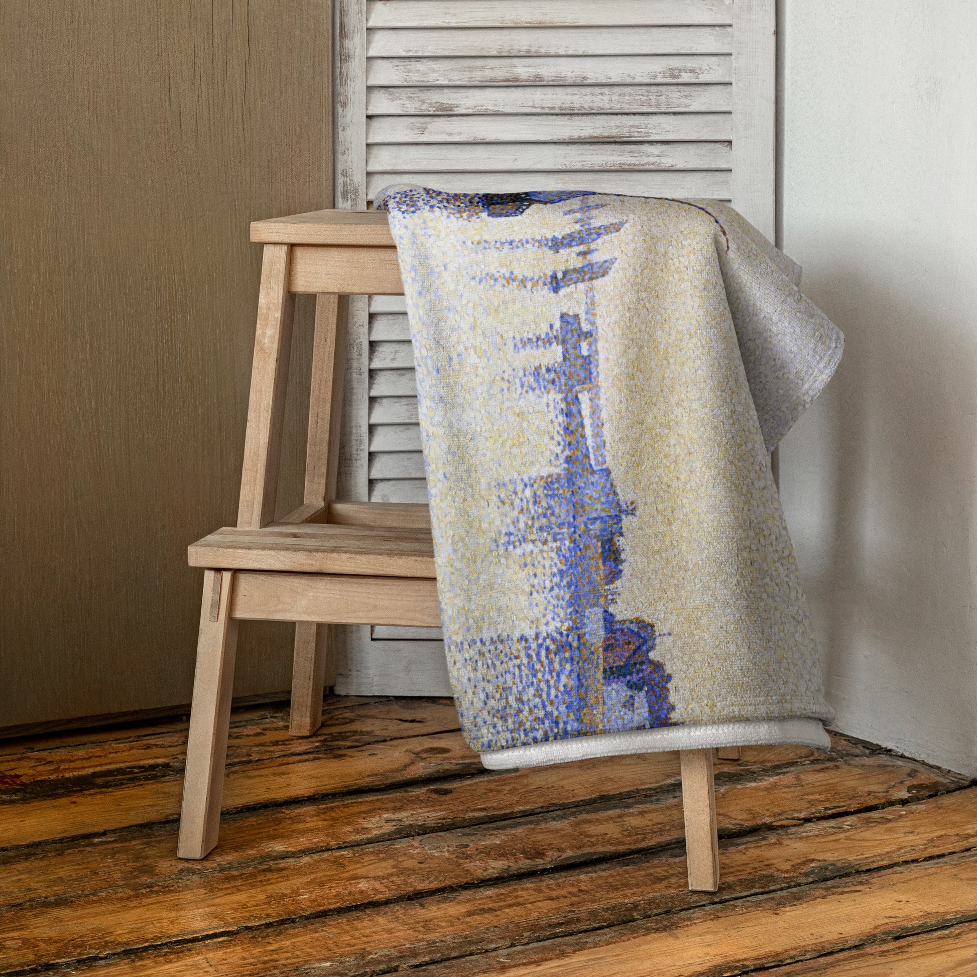 Beach towel featuring painting 'Evening calm, Concarneau' by Paul Signac, hanging over a chair in a room