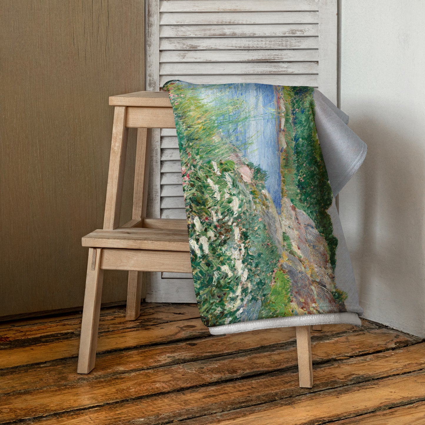 Beach towel featuring painting 'The little pond, Appledore' by Frederick Childe Hassam, hanging over a chair in a room