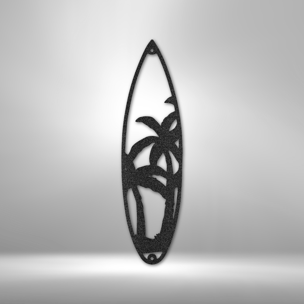 Decorative black steel sign in shape of a surf board with palm tree design shown in close up